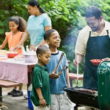 family enjoying a backyard bbq