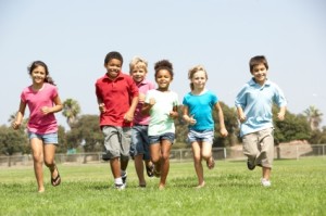 Group Of Children Running In Park