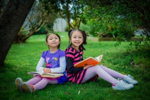 two girls reading in a park