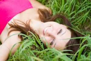 woman lying in green grass